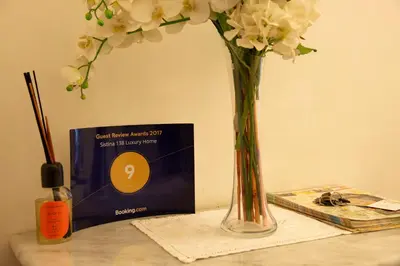 a vase with flowers on a table next to a box at Sistina 138 Luxury Home in Rome