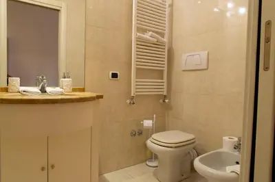 a bathroom with a toilet and a sink at Sistina 138 Luxury Home in Rome