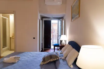a bedroom with a bed with a blue comforter at Sistina 138 Luxury Home in Rome