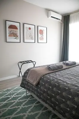 a bedroom with a bed and four pictures on the wall at Sara's Home - Modern Apartment Near Metro, Perfect for Families and Groups in Rome in Rome