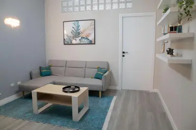 a living room with a couch and a coffee table at Sara's Home - Modern Apartment Near Metro, Perfect for Families and Groups in Rome in Rome