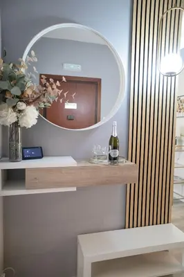 a dressing table with a mirror and a bottle of wine at Sara's Home - Modern Apartment Near Metro, Perfect for Families and Groups in Rome in Rome