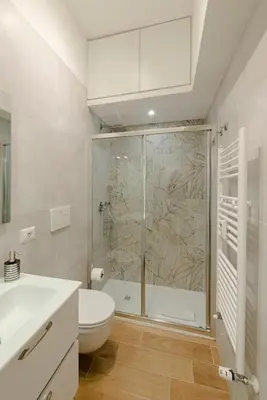 a bathroom with a shower and a toilet and a sink at GoldStar apartments in Rome