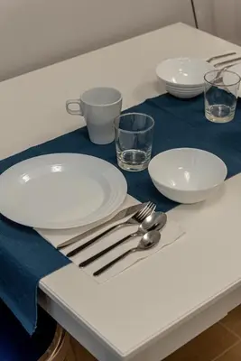 a table with plates and utensils on a table at GoldStar apartments in Rome