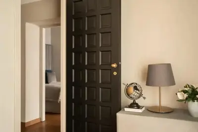 a door in a room with a lamp and a globe at pantheon suite 11 in Rome