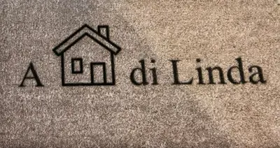 a house on a towel with the words alorida at A casa di Linda in Rome