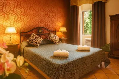 a bedroom with a bed with two towels on it at Hotel Giubileo in Rome