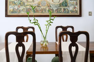 a dining room table with two chairs and a vase with flowers at Casa NeLLa, Apartment with 2 bedrooms, Rome in Rome