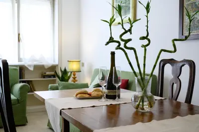 a dining room table with wine bottles and glasses at Casa NeLLa, Apartment with 2 bedrooms, Rome in Rome