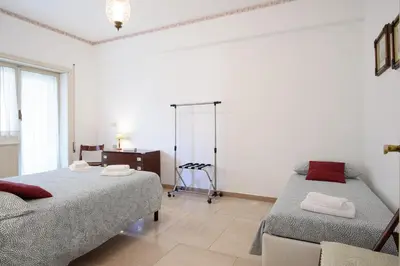 a bedroom with two beds and a dresser in it at Casa NeLLa, Apartment with 2 bedrooms, Rome in Rome