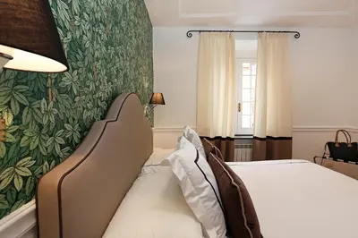 a bedroom with a bed and a green wall at Domus Leonina - Stunning Terrace on the Roman Forum in Rome
