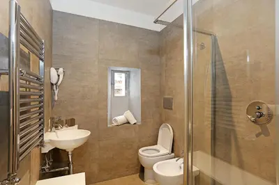 a bathroom with a toilet and a sink and a shower at Domus Leonina - Stunning Terrace on the Roman Forum in Rome