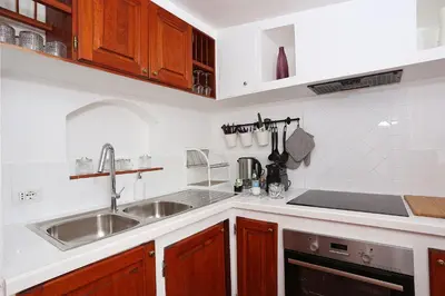 a kitchen with a sink and a counter top at Domus Leonina - Stunning Terrace on the Roman Forum in Rome
