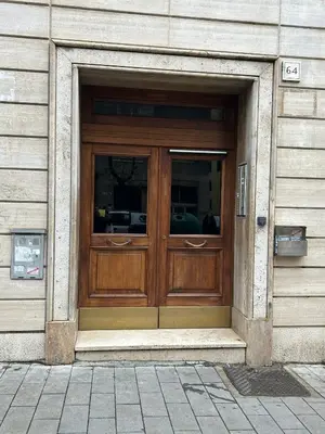 a large wooden door on a building at San Giovanni Studio in Rome