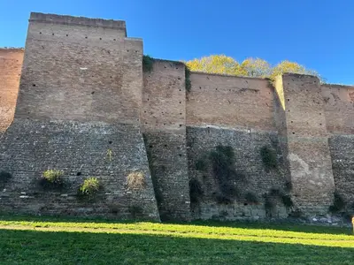 a large brick wall with plants on it at San Giovanni Studio in Rome
