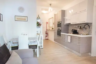 a kitchen and living room with a couch and a table at Sidama Boutique Stay in Rome