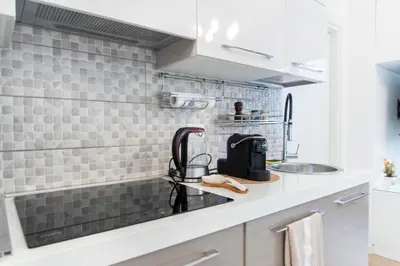 a kitchen with a sink and a counter top at Sidama Boutique Stay in Rome