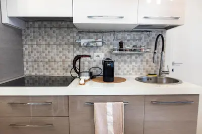 a kitchen counter with a coffee maker and a sink at Sidama Boutique Stay in Rome