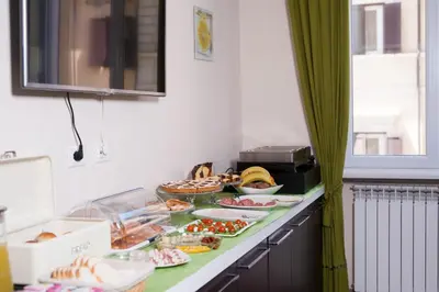 a buffet with many different types of food on a counter at HOTIDAY Room Collection - Roma Barberini in Rome