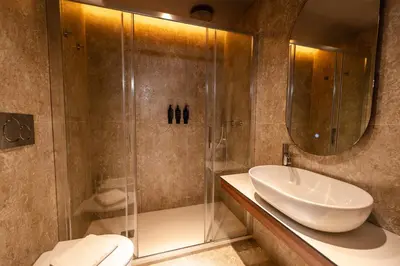a bathroom with a sink and a shower at Whim Collection Trastevere in Rome
