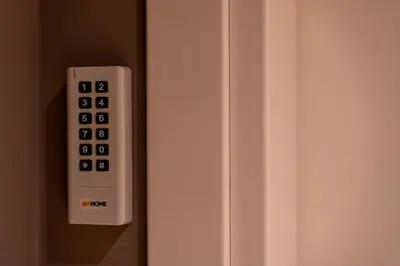 a white remote control on a white refrigerator at Whim Collection Trastevere in Rome