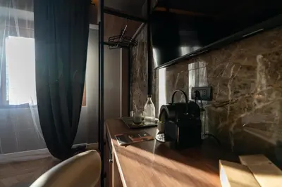 a kitchen with a counter top with at Whim Collection Trastevere in Rome