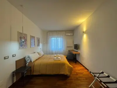 a small bedroom with a bed and a window at Papa's Apartment - A new flat in Portuense in Rome