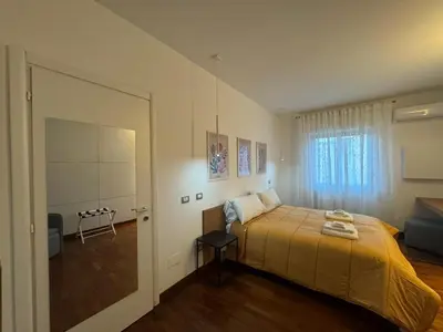 a bedroom with a bed with a yellow bedspread at Papa's Apartment - A new flat in Portuense in Rome