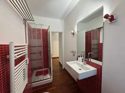a bathroom with a sink and a mirror at Papa's Apartment - A new flat in Portuense in Rome