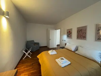 a bedroom with a large bed with two towels on it at Papa's Apartment - A new flat in Portuense in Rome