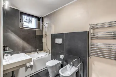 a kitchen with white cabinets and a counter with a microwave at The Loft Trastevere in Rome