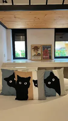 a bed with four black cats pillows on it at Terrazza segreta del Vaticano in Rome