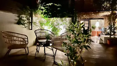 a patio with two chairs and a table with plants at Terrazza segreta del Vaticano in Rome