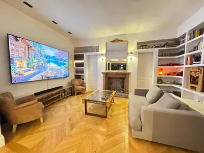 a living room with a large tv on the wall at Terrazza segreta del Vaticano in Rome
