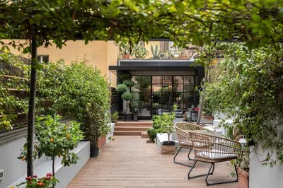 a patio with chairs and potted plants at Terrazza segreta del Vaticano in Rome