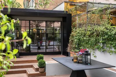 a patio with a table in front of a building at Terrazza segreta del Vaticano in Rome