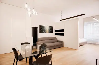 a living room with a glass table and a couch at Appartamento Roma Sallustiano in Rome
