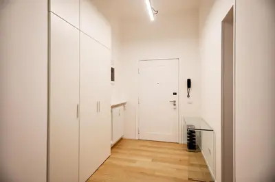 a hallway with white cabinets and a door at Appartamento Roma Sallustiano in Rome