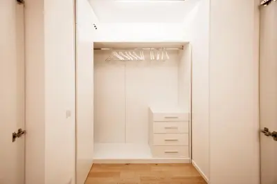 a walk in closet with white cabinets and a mirror at Appartamento Roma Sallustiano in Rome