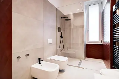 a bathroom with a white toilet and a sink at Appartamento Roma Sallustiano in Rome