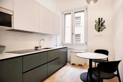 a kitchen with a sink and a table and chairs at Appartamento Roma Sallustiano in Rome