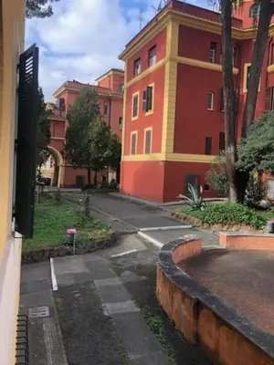 an empty street in front of a large building at Mattia Home in Rome