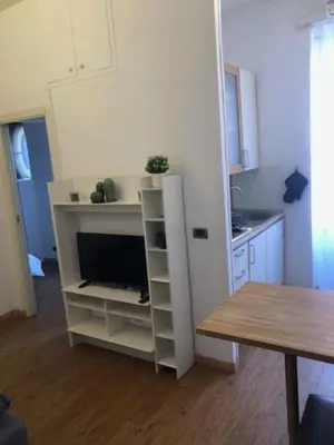 a kitchen with a tv in a white cabinet at Mattia Home in Rome