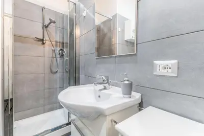 a bathroom with a sink and a shower at Battistini Sweet House in Rome