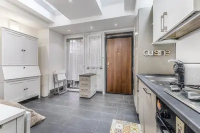 a kitchen with white cabinets and a sink at Battistini Sweet House in Rome