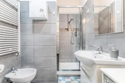 a bathroom with two sinks and a shower at Battistini Sweet House in Rome
