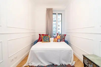 a bedroom with a bed with pillows and a window at Vatican Boutique RHome in Rome
