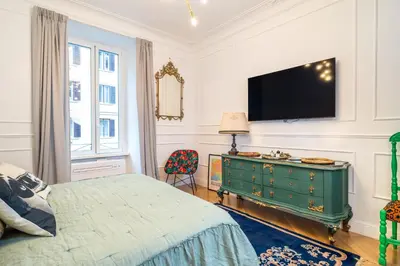 a bedroom with a green dresser and a flat screen tv at Vatican Boutique RHome in Rome