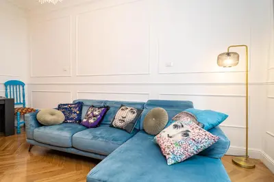a blue couch with pillows in a living room at Vatican Boutique RHome in Rome