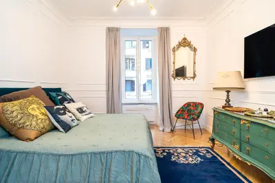 a bedroom with a bed and a dresser and a mirror at Vatican Boutique RHome in Rome